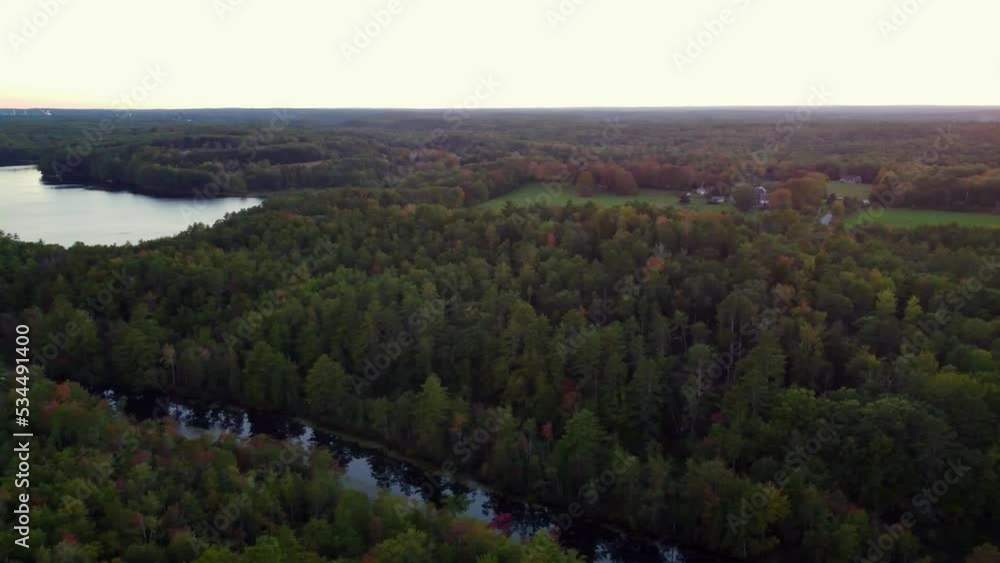 A panning drone shot of a forest and lake in Woolwich Maine. A panning drone shot of a forest and lake in Woolwich Maine.