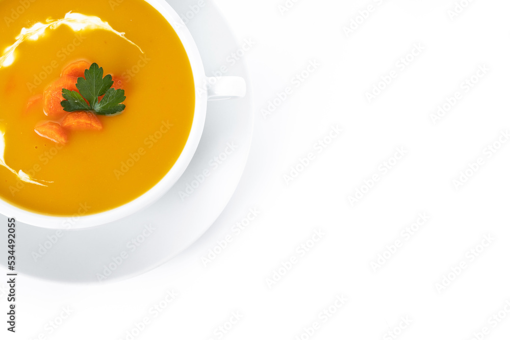 Carrot soup with cream and parsley isolated on white background. Top view. Copy space Carrot soup with cream and parsley isolated on white background. Top view. Copy space