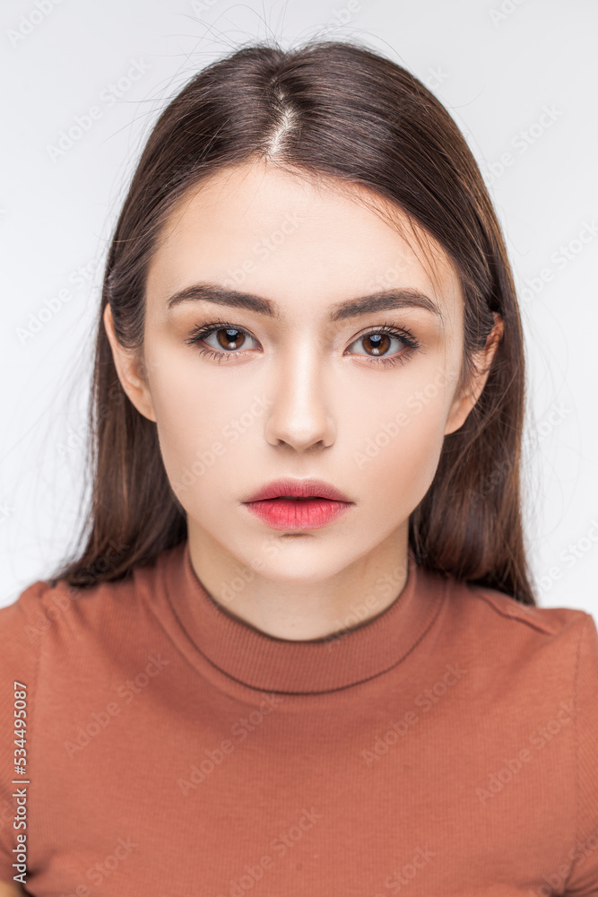 Fototapeta premium Portrait of a young beautiful brunette model, isolated on white background