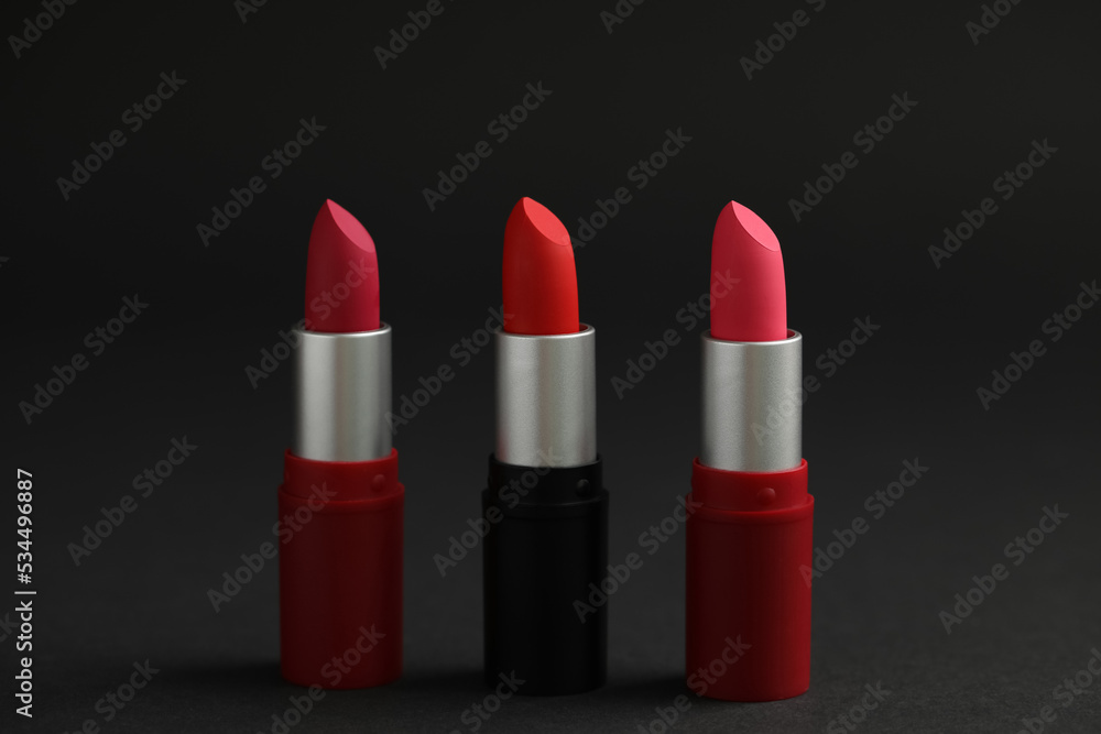 Different lipsticks on black background. Cosmetic product Different lipsticks on black background. Cosmetic product