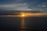 seascape of a calm Atlantic Ocean at sunset with an expressive sky