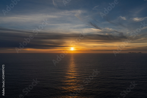 seascape of a calm Atlantic Ocean at sunset with an expressive sky