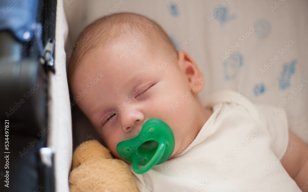Close-up detail view of cute little peaceful baby calm sleeps soundly with pacifier in his crib. Extreme close-up portrait of beautiful child sleeping and resting Close-up detail view of cute little peaceful baby calm sleeps soundly with pacifier in his crib. Extreme close-up portrait of beautiful child sleeping and resting