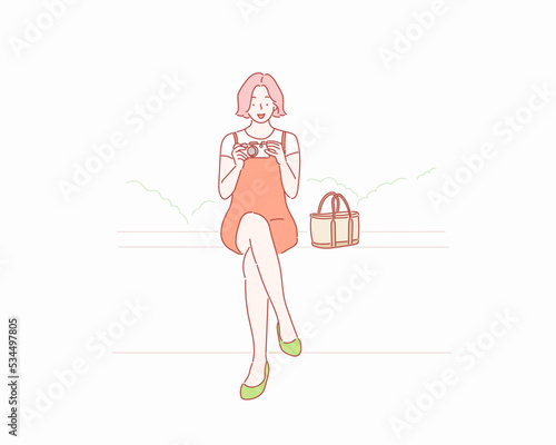 Beautiful girl photographer with old camera. Hand drawn style vector design illustrations.