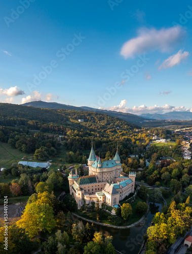 vertical drone view of Bojnice Castle in Slovakia in warm evening light