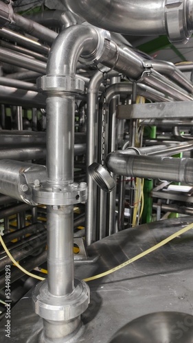 Industrial background of the unconnected stainless steel pipeline in production room 