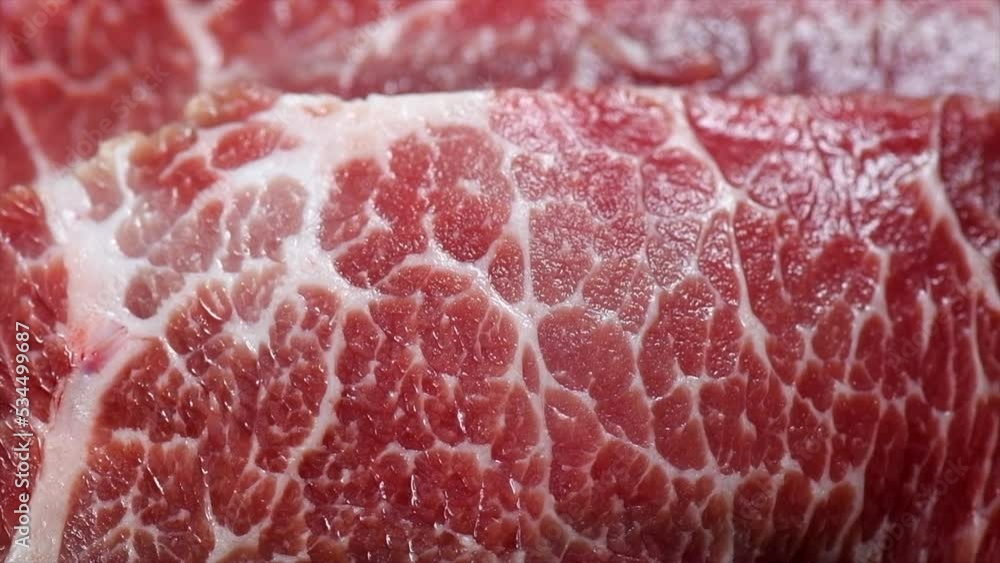 Raw meat background. Prime fillet meat. Marble beef steak Black Angus Steak Rib eye. Slow motion Raw meat background. Prime fillet meat. Marble beef steak Black Angus Steak Rib eye. Slow motion