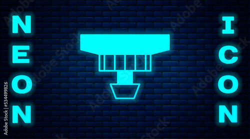 Glowing neon Smoke alarm system icon isolated on brick wall background. Smoke detector. Vector