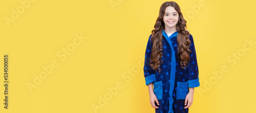 cheerful teen girl with curly hair in comfortable pajama, homewear. Child face, horizontal poster, teenager girl isolated portrait, banner with copy space.