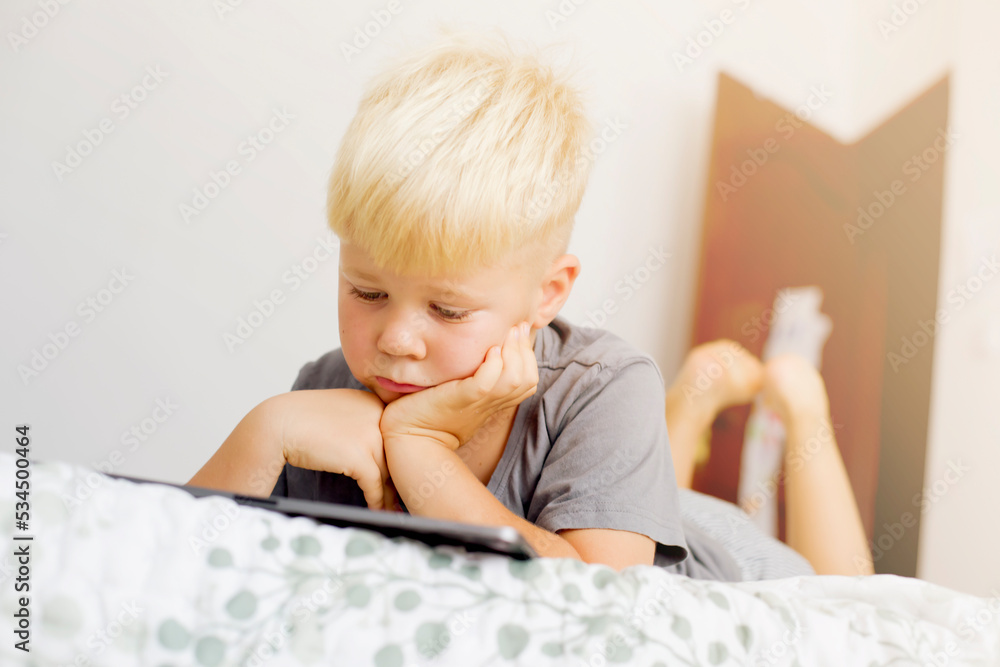 blondy boy spend your leisure time with tablet at home blondy boy spend your leisure time with tablet at home