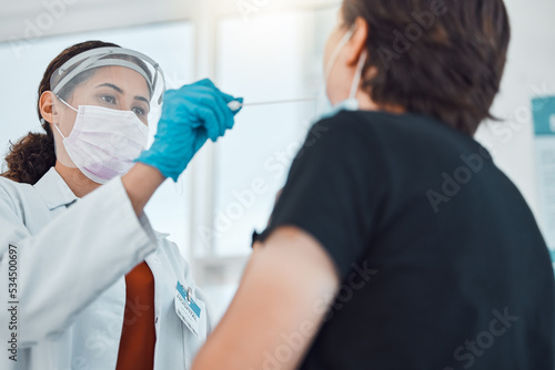 Covid doctor, swab and coronavirus test on patient in hospital for healthcare and medical insurance while wearing face mask for safety and protection. Female gp taking from woman for virus in clinic