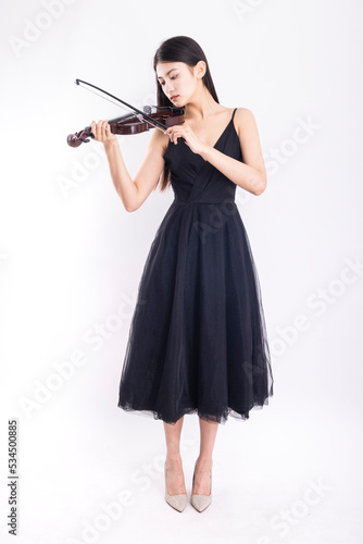 Young woman playing violin on white background