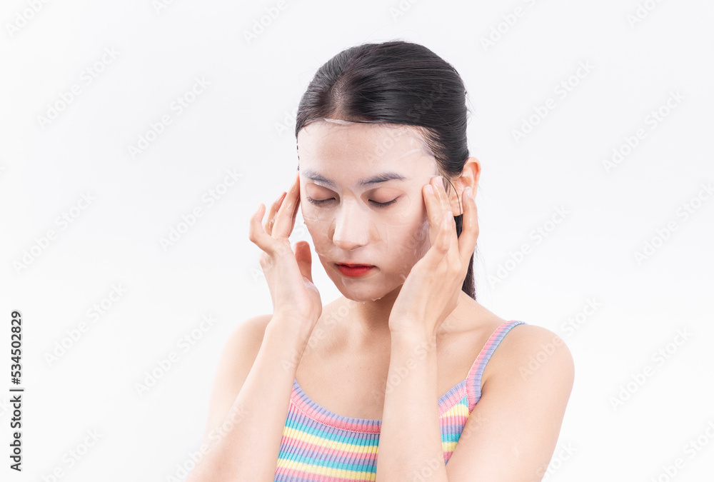 A young woman wearing a facial mask against a white background A young woman wearing a facial mask against a white background