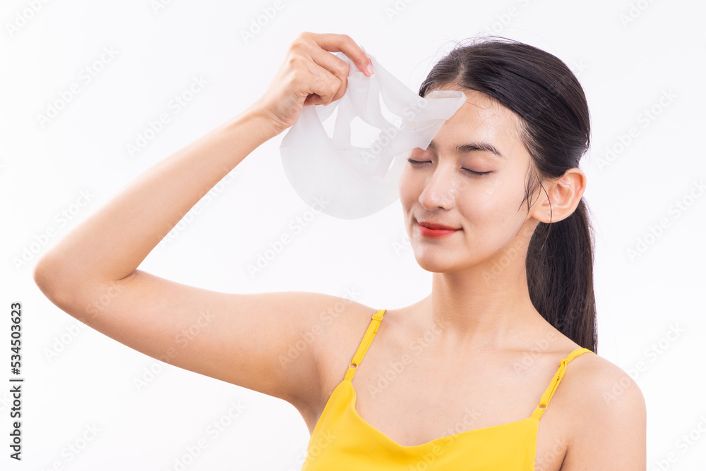 A young woman wearing a facial mask against a white background A young woman wearing a facial mask against a white background