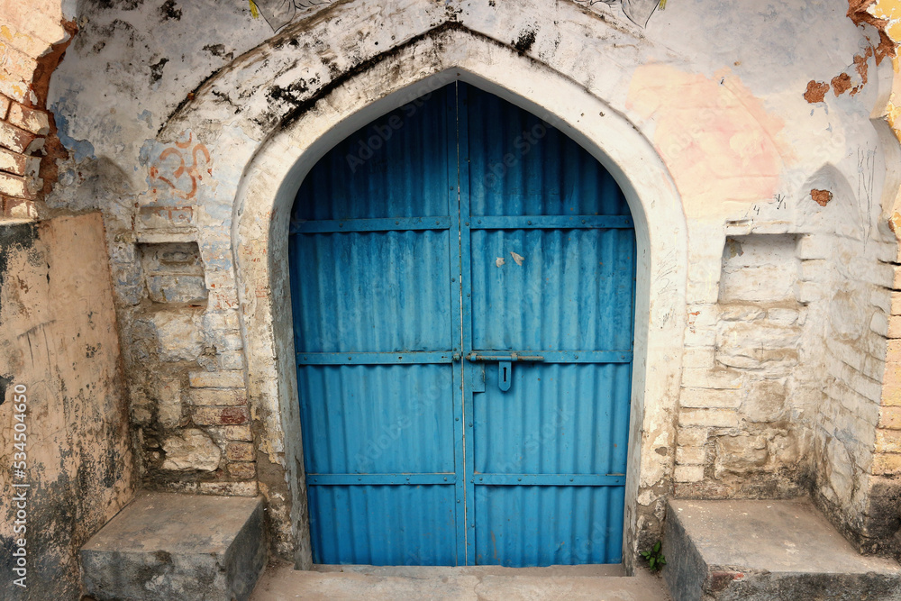 Old blue gate, ancient entrance in India, Rishikesh.