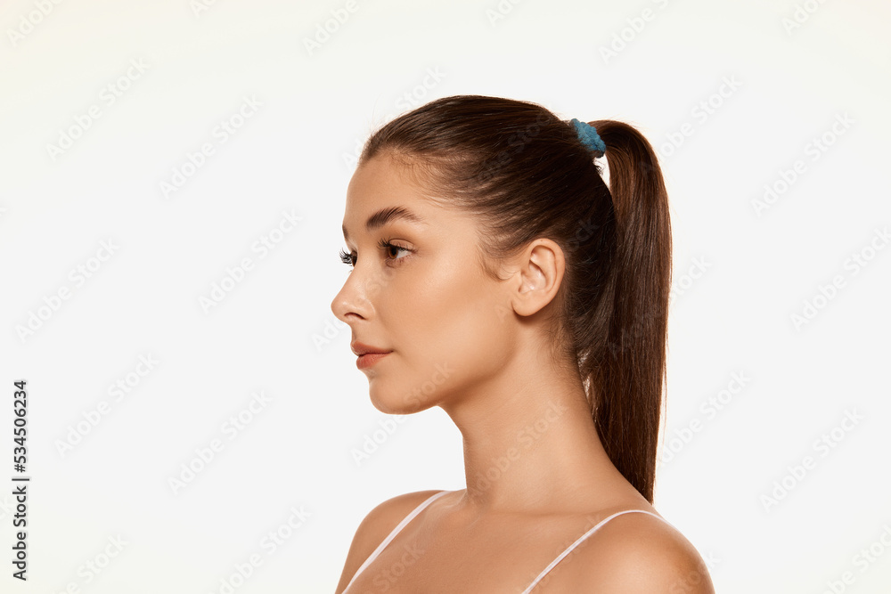 Portrait of young beautiful woman with clear spotless skin isolated over white background. Perfect face shape. Portrait of young beautiful woman with clear spotless skin isolated over white background. Perfect face shape.