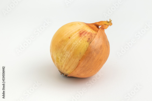 close up of raw onion with the skin isolated on white background