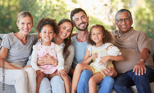 Portrait family, interracial smile and grandparents happy on living room sofa with children, smile together in lounge and relax on couch in house. Kids, mother and father with senior people for visit