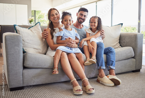 Parents, kids and happy family home portrait on living room sofa, couch and lounge to relax, quality time and fun together in Spain. Smile mom, dad and young girl children with love, support and care