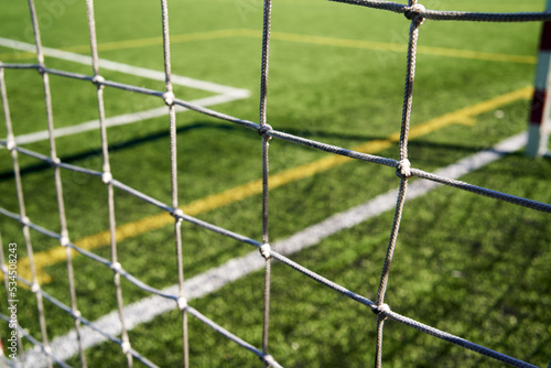 String net at a football playground, with green grass behind
