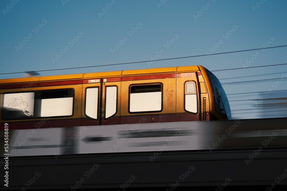 Fototapeta premium Yellow train against the background of the blue sky. Berlin, Germany.