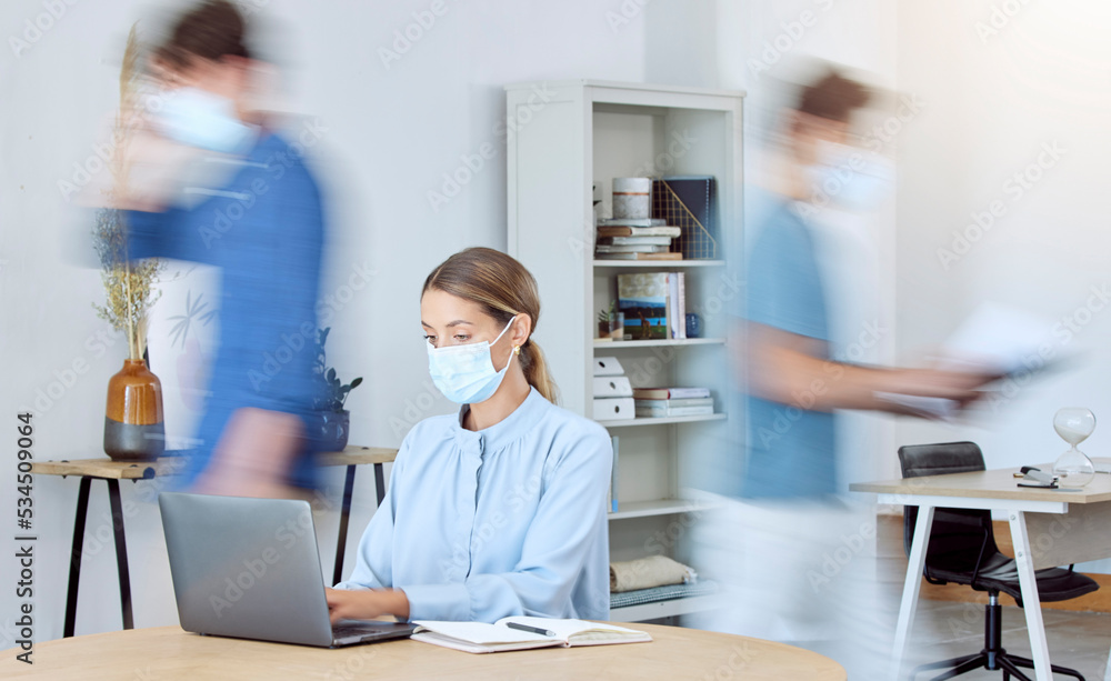 Business woman, busy office and covid compliance while on laptop and blur of people around her. Employees in the office during coronavirus wearing face mask and working in company after lockdown