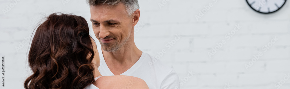 custom made wallpaper toronto digitalSmiling man looking at brunette wife in kitchen, banner.