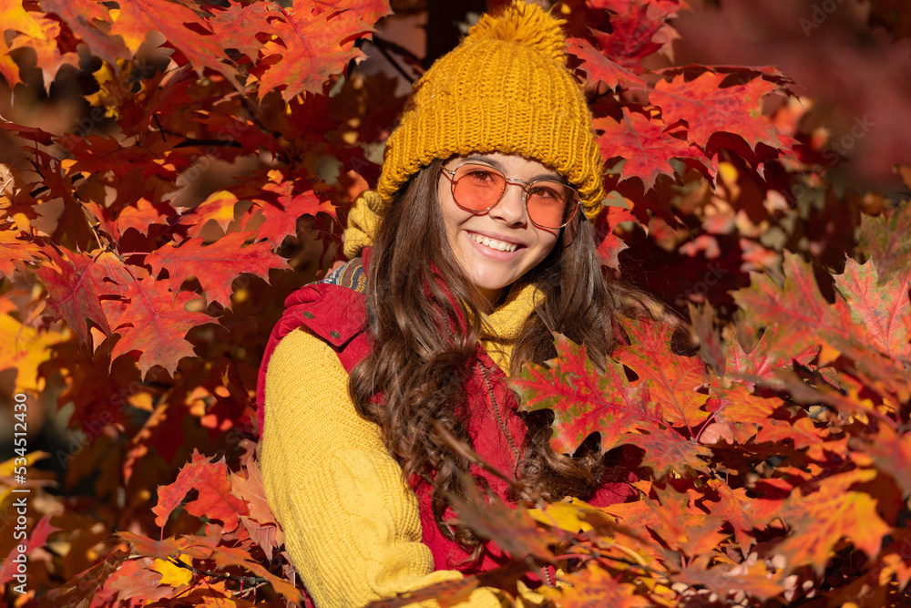 Child girl on autumn fall background, autumn kids face. happy child in sunglasses at autumn leaves on natural background Child girl on autumn fall background, autumn kids face. happy child in sunglasses at autumn leaves on natural background