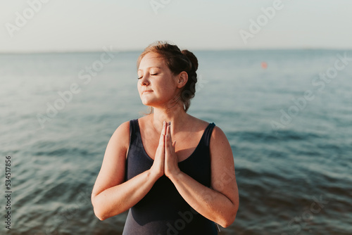 Close up portrait of attractive meditating woman smiling brunette confident pretty photo