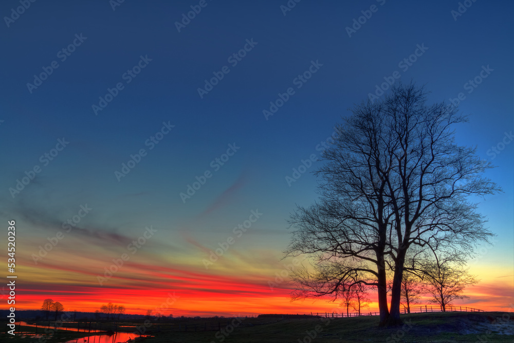 Landscape sunset or sundown river Narew Poland Europe spring time meadows under water Landscape sunset or sundown river Narew Poland Europe spring time meadows under water
