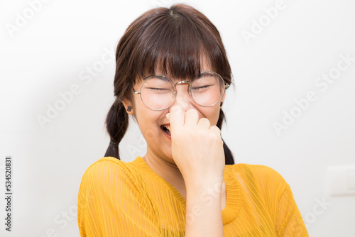 Portrait of beautifula asian smiling woman yellow shirt photo