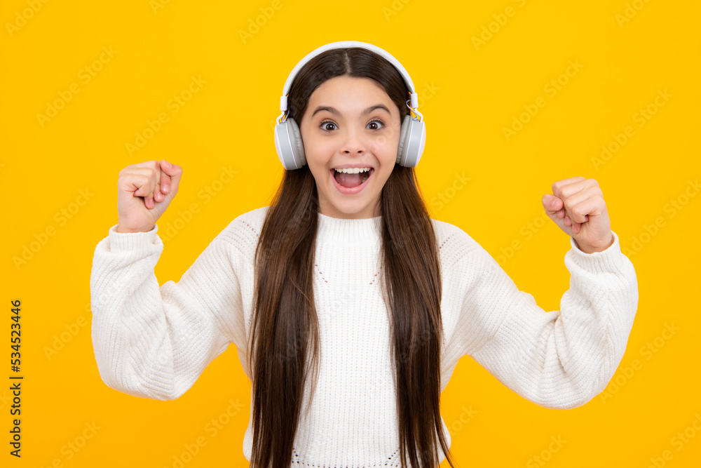 Child music concept. Teenager child girl dances in rhythm of melody, listens song in headphones. Child listening to music through earphones. Child music concept. Teenager child girl dances in rhythm of melody, listens song in headphones. Child listening to music through earphones.