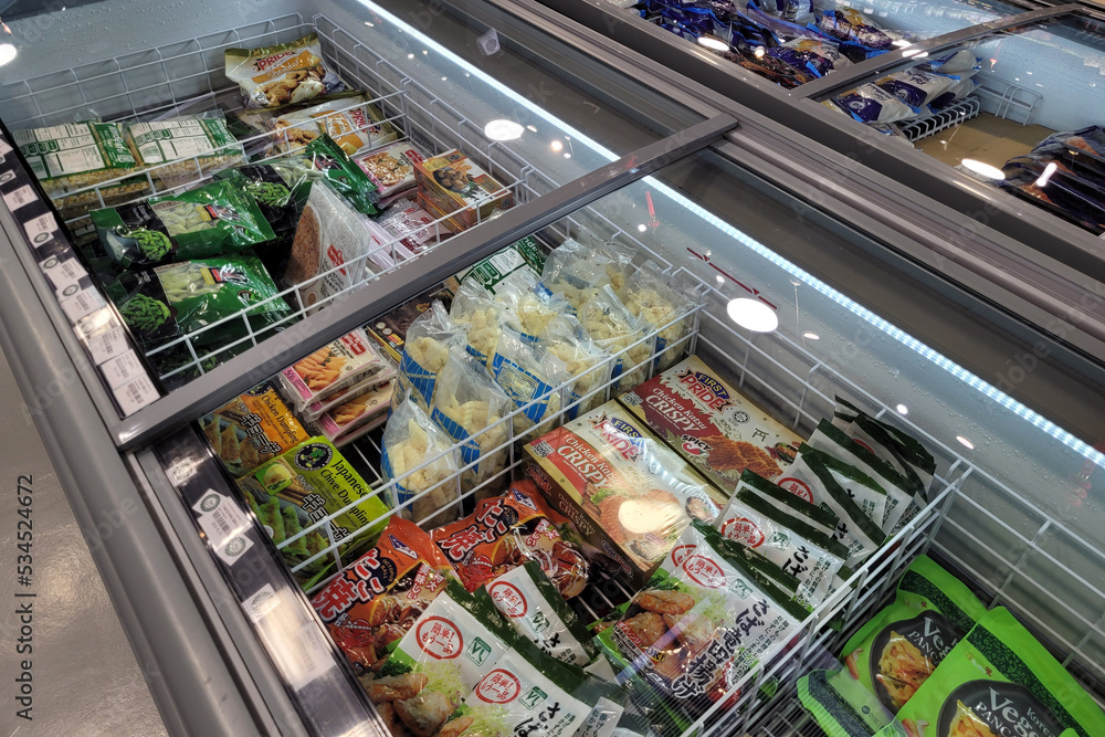 Penang, Malaysia 24 SEP 2022 Huge fridge with various choice frozen foods in a grocery store
