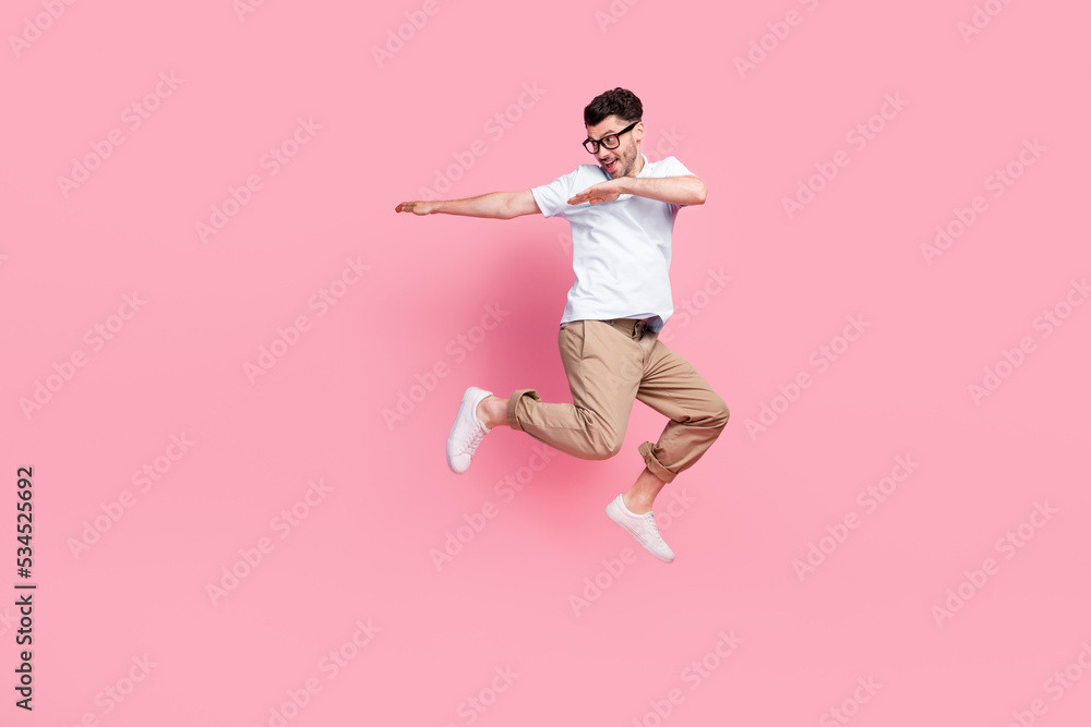 Full length photo of positive nice man interested look empty space dressed stylish clothes empty space isolated on pink color background Full length photo of positive nice man interested look empty space dressed stylish clothes empty space isolated on pink color background