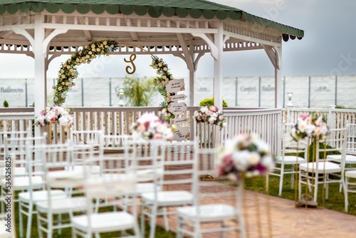 View of a waterside decorated wedding venue in the evening