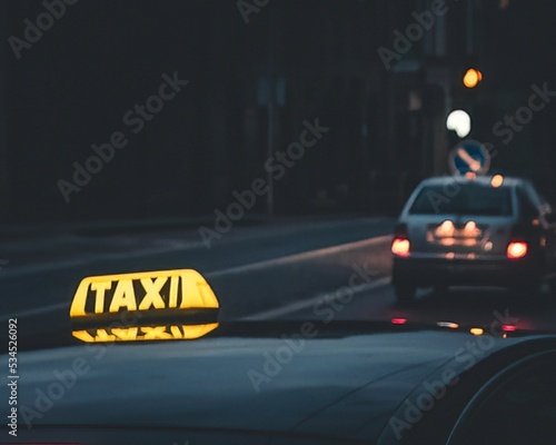 Canvas Print Closeup shot of an illuminated taxi sign on a car top