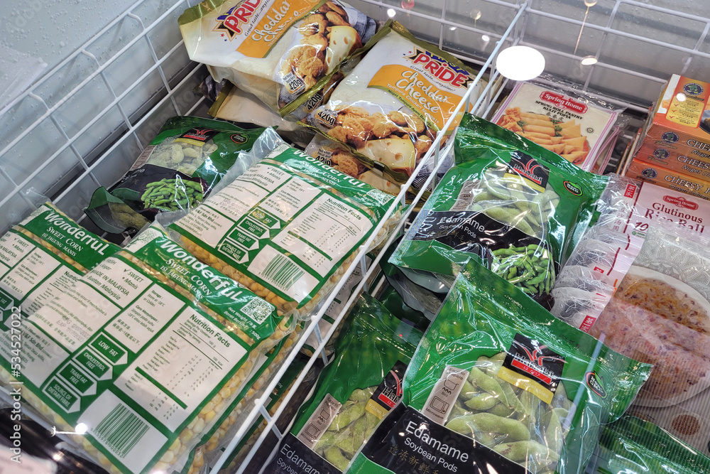 Penang, Malaysia 24 SEP 2022 Huge fridge with various choice frozen foods in a grocery store