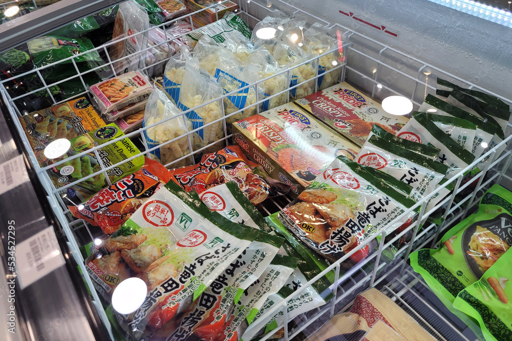 Penang, Malaysia 24 SEP 2022 Huge fridge with various choice frozen foods in a grocery store