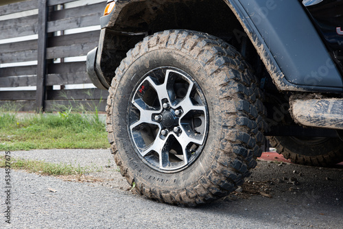 Dried mud on SUV's off-road mud tires. Close up low angle view, no people © Octavian