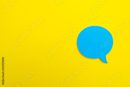 blue empty chat bubble on yellow background