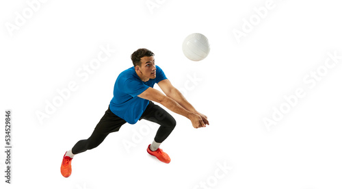 Dynamic portrait of male volleyball player training with ball isolated on white studio background. Sport, gym, team sport, challenges © master1305