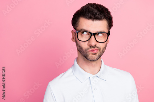 Closeup photo of young handsome funny positive interested guy wear white polo pouted lips distrust look empty space idea isolated on pink color background © deagreez