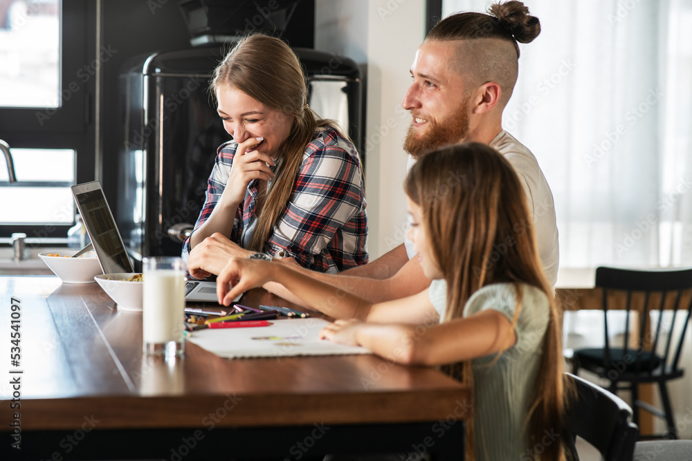 Young modern parents are sitting in the living room with their daughter and eating healthy breakfast.
Young modern parents are sitting in the living room with their daughter and eating healthy breakfast.