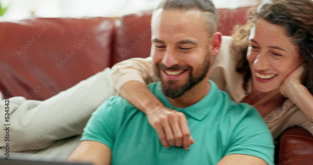 Couple relax on sofa with laptop watch comedy, funny show or social media meme together in their