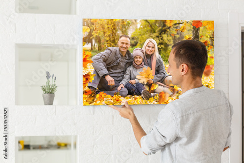 Canvas print with gallery wrap. man hangs autumn photography, photocanvas photo