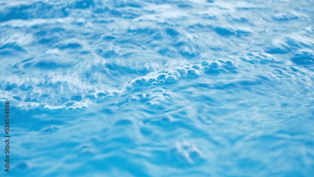 Clean blue water surface texture. Swimming pool. Side view, summer vacation, aqua relaxing background. Clean blue water surface texture. Swimming pool. Side view, summer vacation, aqua relaxing background.