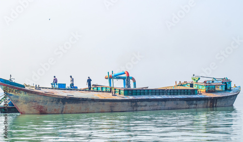 The industrial extraction of sand for construction. The pipe abrasives sand with water under strong pressure. A river vessel extracts sand from the bottom of the river.