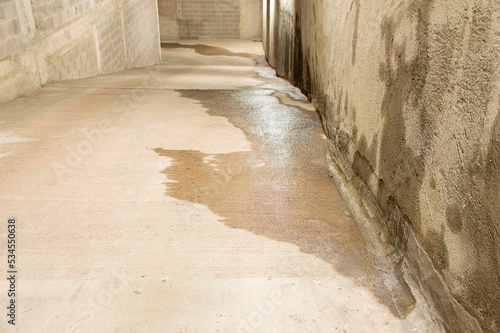 Fényképezés Entrance to a parking lot with entrance of outside water caused by heavy rains