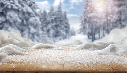 Wooden table with snow at sunset on a frosty winter's day and a free seat