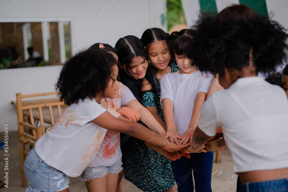 teacher and children playing color in Art join hand in hand fun together teacher and children playing color in Art join hand in hand fun together